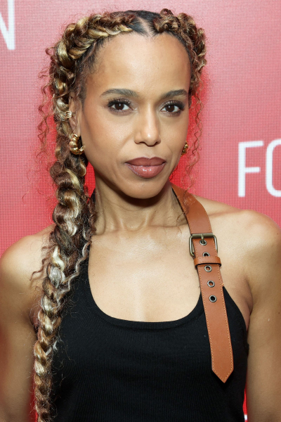 Kerry Washington poses at an event in a black top and a blonde braid.